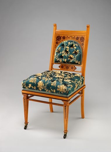 A late-19th-century light/medium wood chair with darker wood inlay and silky green and gold upholstery.