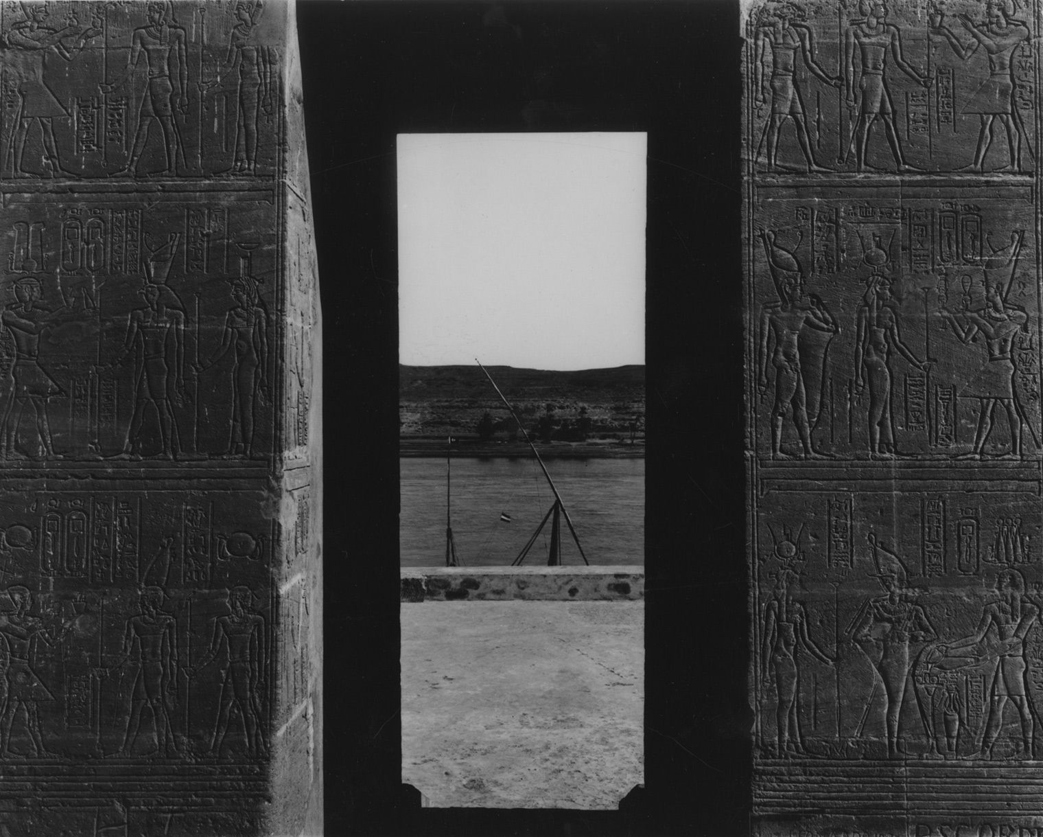 A black and white photograph of the view from the gateway of the Temple of Dendur, looking towards the Nile.