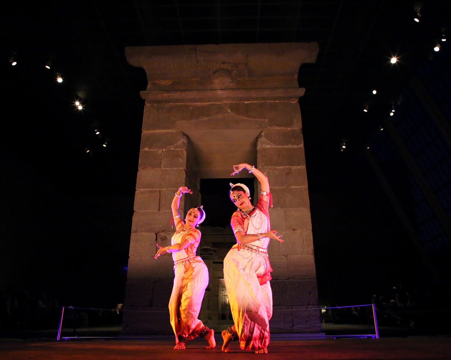 Two artists from the Nrityagram Dance Ensemble, principal dancers Surupa Sen and Bijayini Satpathy, perform in front of the temple's gateway, January 2015.