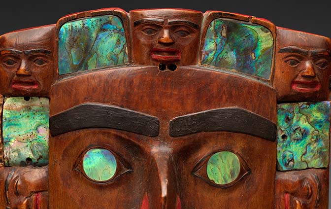 A headdress frontlet worn by Tsimshian leaders made from wood, abalone shell, pigment, and nails