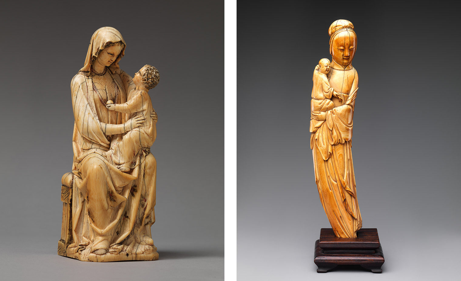 Two figurines of mothers holding a child